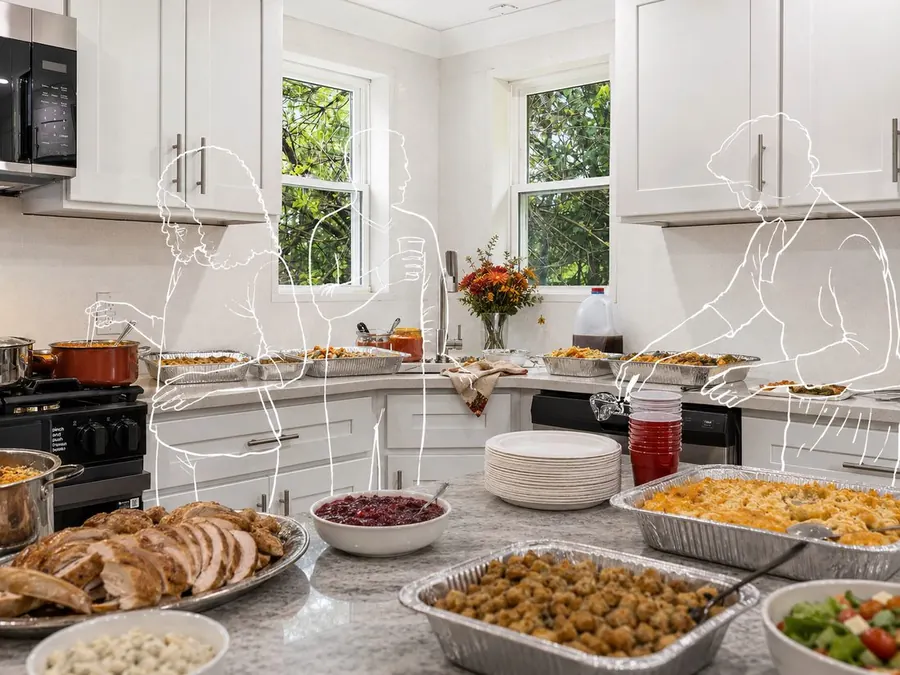The kitchen staged mid-Thanksgiving with food across the counters and line-drawn figures